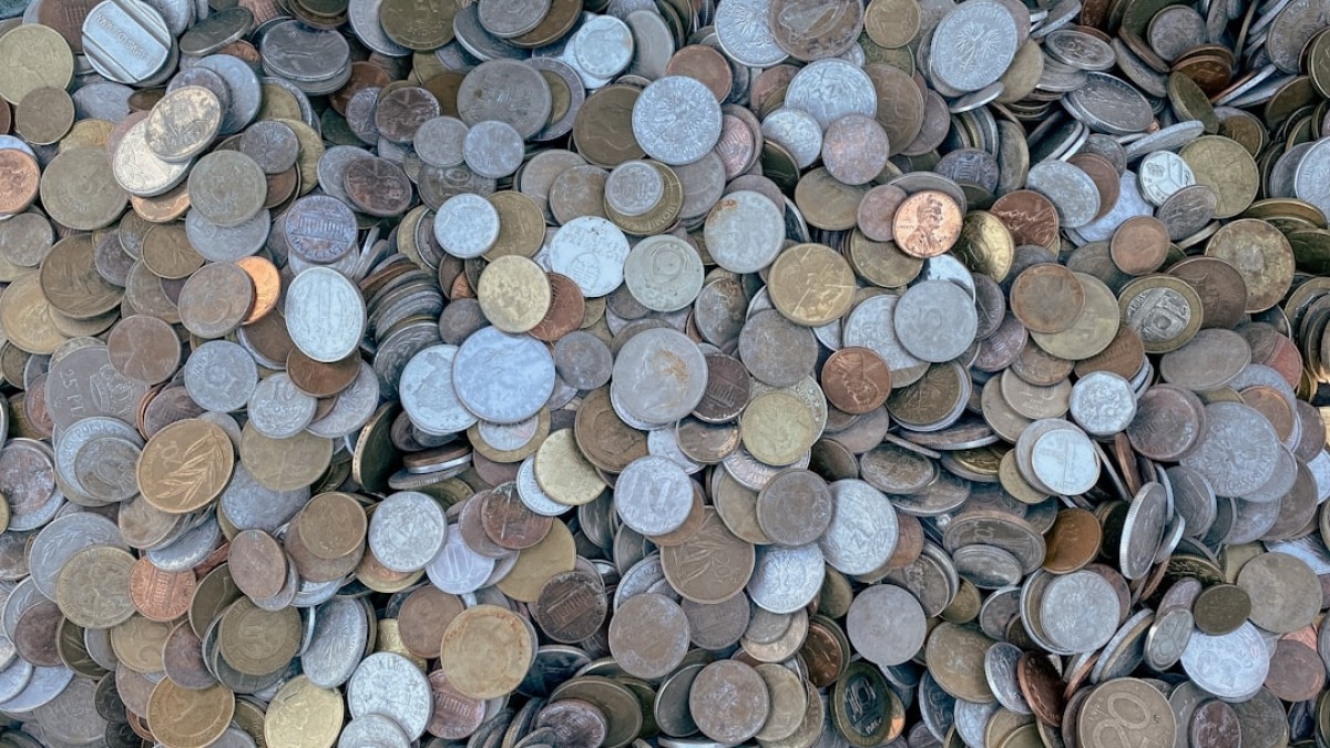 a pile of different types of coins