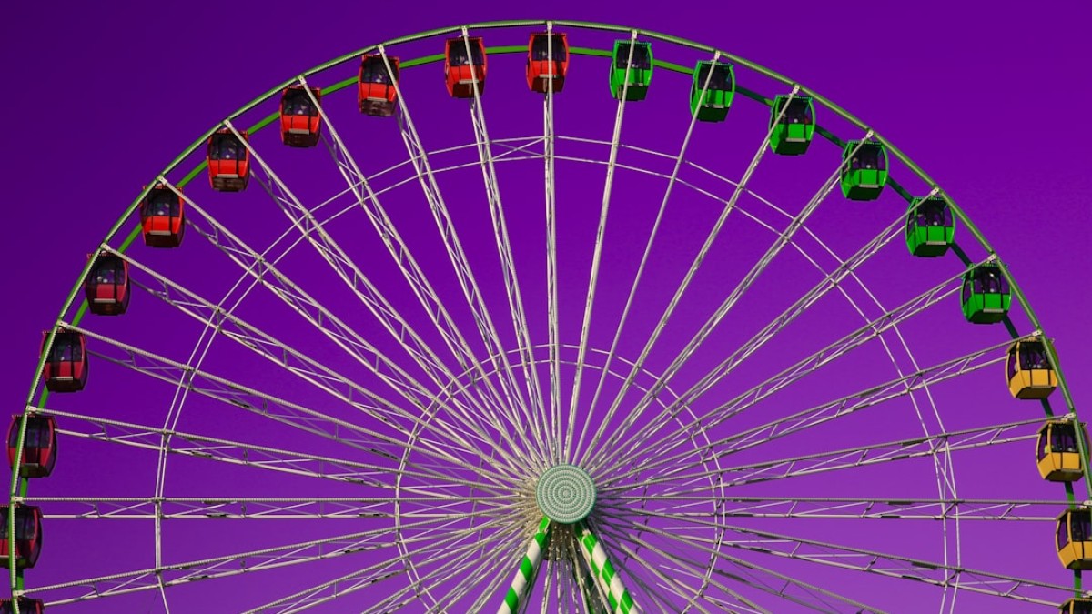 a ferris wheel with a purple sky in the background
